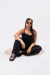 Pantalón palazzo negro de corte wide leg, confeccionado en tela ligera con caída y cintura elastizada de tiro medio-alto.