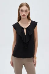 Blusa negra de viscosa sin mangas, con cuello redondo, volados frontales y detalle de lazo en el escote.