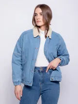 Campera de jean celeste con cuello de corderito color crema, bolsillos delanteros, botones metálicos y elástico en el ruedo.