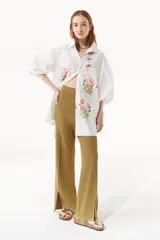 Pantalón de tejido de punto acanalado, de tiro alto y corte de pierna ancha, con detalle de tajo frontal en el ruedo.