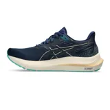 Championes de running Asics GT-2000 12 para mujer, color azul marino con entresuela blanca, detalles en dorado y suela verde turquesa. Confeccionados en tejido de malla transpirable, incorporan tecnología FF Blast+ y PureGel para mayor amortiguación.