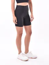 Calza corta tipo biker de color negro, de tiro alto y diseño ajustado.