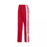 Pantalón deportivo Adidas modelo Adibreak, color rojo con franjas laterales blancas y botones a presión a lo largo de las piernas. Presenta el logo de la marca y detalles gráficos en la parte inferior.