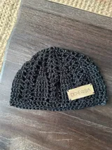 Gorro negro tejido a crochet con hilo de algodón.