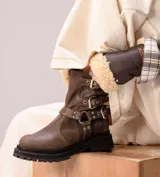 Botas de caña media color negro, confeccionadas en cuero natural, con suela track y plataforma alta. Cuentan con múltiples correas con hebillas metálicas plateadas y tachas decorativas.