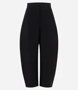 Pantalón de sastrería en crepé color negro, con modelaje barrel, cintura estructurada con pasadores para cinturón, bolsillos traseros embutidos y piernas amplias con ruedo levemente afinado.