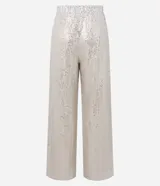 Pantalón pantalona confeccionado en tejido de punto abierto con elástico en la cintura y lentejuelas metalizadas aplicadas.