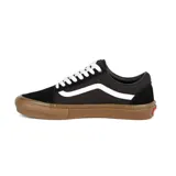 Championes Vans modelo Skate Old Skool, de color negro con la icónica banda lateral blanca y suela de goma color caramelo. Presentan un diseño clásico de perfil bajo con cordones blancos y etiqueta de tablero de ajedrez en el lateral.