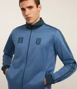 Saco deportivo celeste confeccionado en helanca, con cuello alto, cierre por cremallera, manga larga, estampa lettering y detalles contrastantes.