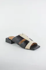 Sandalias descalzas de cuero combinadas en negro y beige, con taco cuadrado bajo y puntera cuadrada.
