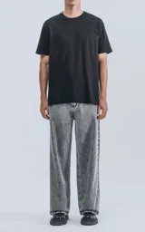 Remera de manga corta y cuello redondo, color negro, confeccionada en algodón premium de tacto suave. Presenta un calce regular con un recorte distintivo en la espalda.