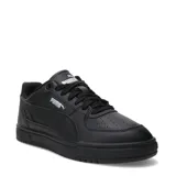 Championes urbanos Puma modelo Caven III, color negro con detalles en plateado. Presentan una silueta clásica de inspiración retro, con perforaciones en la puntera para mayor ventilación y suela de goma resistente.