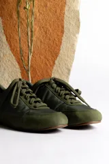 Zapatillas deportivas color crema con detalles en gamuza beige.