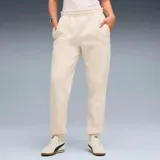 Pantalon de jogging Puma, color beige, con cintura elástica, puños en los tobillos y logo de la marca bordado en la pierna izquierda.