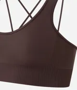 Top deportivo Get Over color azul marino, confeccionado en poliamida sin costuras (seamless), con escote redondo, doble tirante cruzado en la espalda y diseño liso.