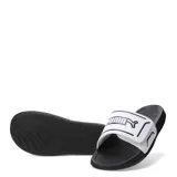Sandalias Puma modelo Royalcat Comfort 2, con base negra y tira superior blanca con el logo de la marca en negro. Presenta un diseño ergonómico con tecnología Softride para mayor amortiguación.