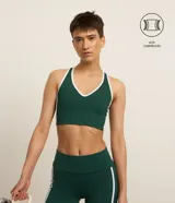 Top deportivo Get Over de microfibra verde oscuro con escote en V y espalda nadador. Presenta bies de color blanco en los bordes y costados.