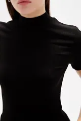Remera de viscosa con textura acanalada, corte al cuerpo, cuello alto y mangas cortas.