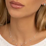 Aros de plata 925 con piedra topacio azul redonda engarzada con cuatro grifas.