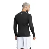 Remera térmica de manga larga Umbro, color negro, con cuello redondo y diseño ajustado al cuerpo. Presenta aberturas para los pulgares en los puños y el logo de la marca estampado en el pecho.