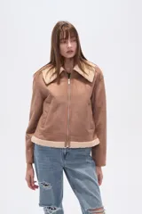 Campera estilo aviador color marrón claro, con cuello y forro de corderito color beige. Presenta cierre frontal y puños y ruedo con terminación de corderito.