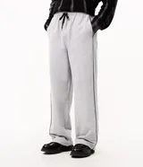 Pantalón de algodón color gris jaspeado, de corte wide leg amplio y recto, con cintura elástica y cordón de ajuste. Cuenta con bolsillos funcionales y detalle de filete lateral en color negro.