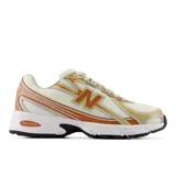 Championes New Balance modelo 740, con diseño inspirado en el running de los años 2000. Presenta una parte superior de malla abierta en color crema con superposiciones sintéticas en tonos naranja y dorado, logotipo N lateral en TPU y entresuela blanca con tecnología ABZORB para amortiguación.