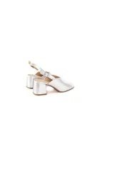 Sandalias de cuero vacuno metalizado en color plateado, con diseño minimalista, punta cuadrada abierta y capellada estilizada con abertura en V. Cuenta con tacón medio en bloque y tira slingback ajustable con hebilla metálica en el talón.
