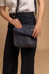 Bandolera de diseño simple con tapa frontal, confeccionada en material símil cuero. Cuenta con correa ajustable, división interna y bolsillos internos para mayor organización.