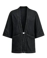 Kimono de denim negro lavado, de manga corta ancha y corte recto. Se cierra al frente con un broche metálico rectangular.
