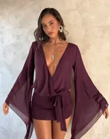 Vestido corto de gasa color bordó, con escote en V cruzado, mangas largas amplias y lazo ajustable en la cintura.