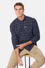 Camisa de viyela a cuadros tipo leñadora, con cuello abotonado, cierre frontal con botones y bolsillo en el pecho.