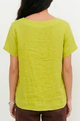 Blusa de lino color verde lima, con escote en V, mangas cortas y detalle de pliegue frontal.