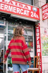 Sweater de tejido de punto con cuello redondo y mangas largas, de corte holgado, con rayas horizontales anchas en tonos marrón y morado.