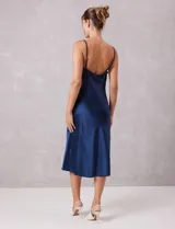 Vestido midi de satén color azul marino, con escote drapeado y breteles finos regulables. Presenta una silueta fluida con caída suave.