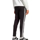 Pantalón de jogging Adidas Essentials Single Jersey negro con tres rayas blancas a los costados y logo de la marca bordado en blanco.