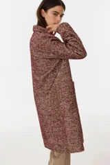 Tapado de paño a cuadros tartán en tonos rojo, azul, amarillo y blanco sobre base negra, con cuello solapa y cierre frontal con botones.