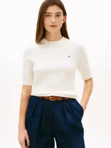 Sweater de punto fino de puro algodón peinado, color blanco, con cuello redondo elástico, manga corta y el logo de Tommy Hilfiger bordado en el pecho.