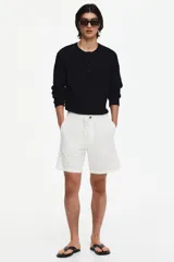 Short de corte regular fit en mezcla de algodón y lino color blanco, con cintura elástica, cordón ajustable, botón frontal, bolsillos laterales y bolsillos traseros ojalados.