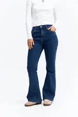 Jean de corte oxford con tiro alto, ajustado hasta la rodilla y con apertura amplia en el bajo. Confeccionado en denim negro con cierre frontal de botón y cremallera.