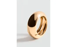 Pulsera rígida de metal dorado con diseño ancho, voluminoso y acabado brillante.