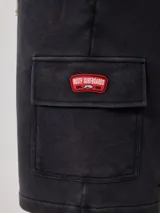 Short deportivo gris con bolsillos cargo laterales y cordón ajustable en la cintura.