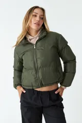 Campera puffer corta color ladrillo, con cuello alto y cierre frontal.