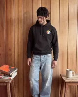 Buzo canguro con capucha color negro, de corte regular y felpa interior. Presenta un estampado gráfico en la espalda que representa un termo antropomórfico sosteniendo globos con letras.