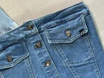 Top strapless de jean con botones blancos y ruedo desflecado.