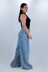Jean wide leg baggy color azul, de tiro medio-alto, con diseño de costuras diagonales y bolsillos cargo laterales.