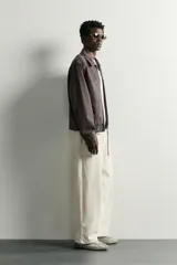 Sobrecamisa regular fit color marrón oscuro efecto lavado, confeccionada en denim de algodón. Cuenta con cuello solapa, manga larga, bolsillos de plastrón en el pecho y cierre frontal con cremallera.