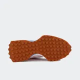 Championes urbanos New Balance modelo 327, con diseño retro inspirado en los años 70. Presentan una combinación de colores rosado y azul, con el logo 'N' sobredimensionado en el lateral, entresuela de espuma acolchada y suela de goma con tacos extendidos hacia el talón.