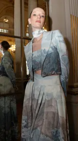 Bustier estructurado de corte spencer, confeccionado en crepe con estampado artístico de paisajes montañosos y glaciares. Presenta detalles de canutillos bordados a mano y un diseño entallado a la cintura.