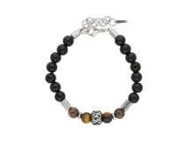 Pulsera de acero con cuentas de ónix negro y ojo de tigre marrón, separadores metálicos y cierre de mosquetón con cadena de alargue.
